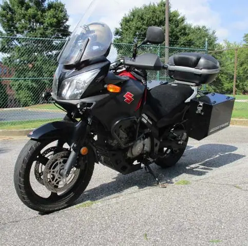 A black motorcycle parked on the side of a road.