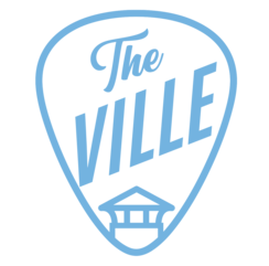 A blue guitar pick with the word " ville " written in it.