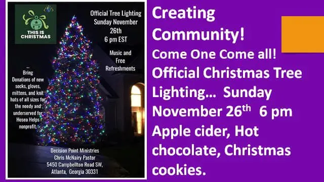 A christmas tree is lit up on the side of the road.