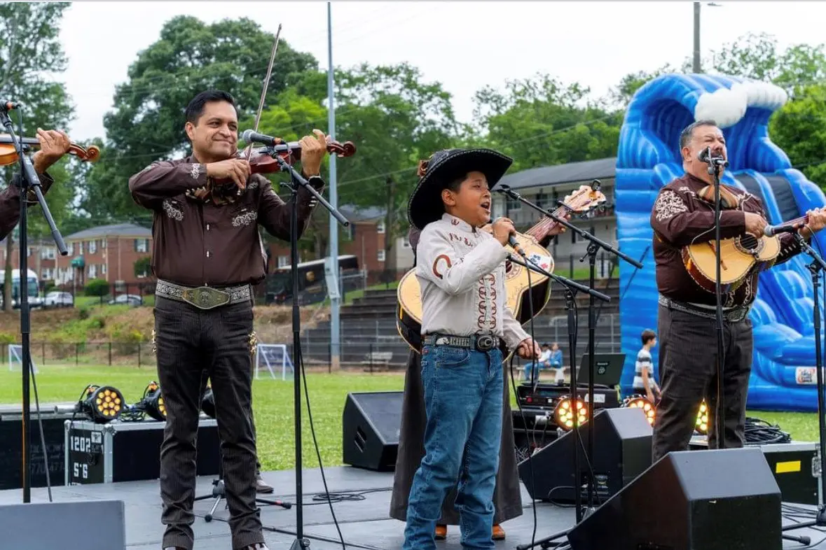 A group of people playing instruments on stage.