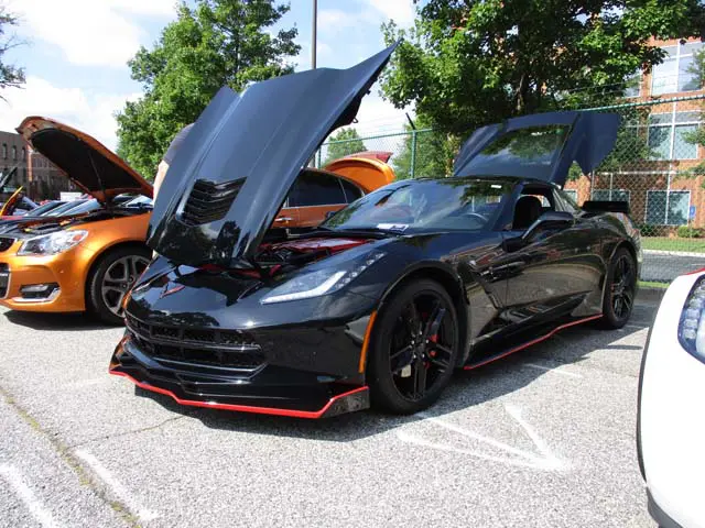 Black sports car with hood open.