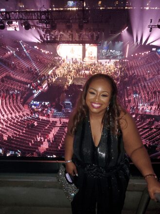 A woman standing in front of an audience.
