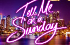 Neon text over city skyline at night.